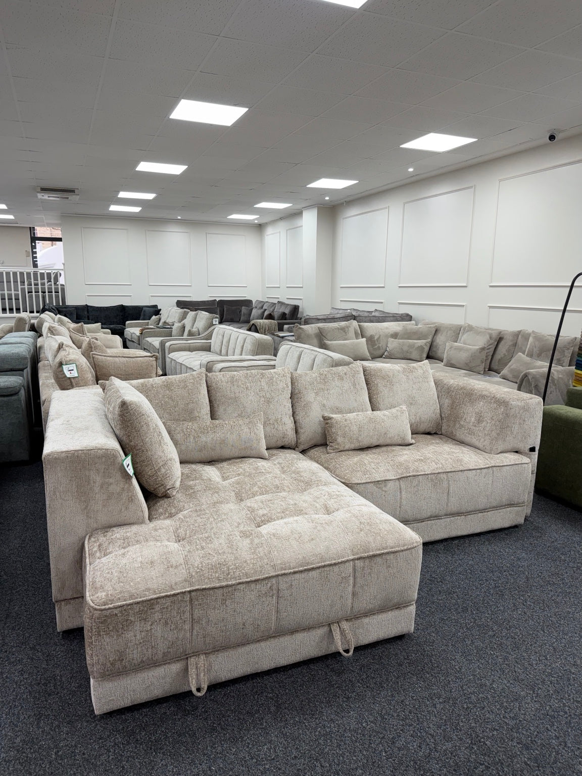 Brooklyn Light Beige left-hand electric storage sofa bed, showroom corner view