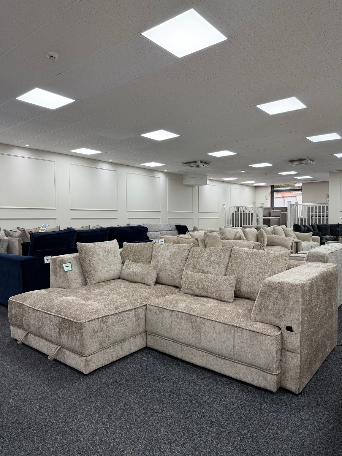 Brooklyn Light Beige left-hand electric storage sofa bed, angled showroom view