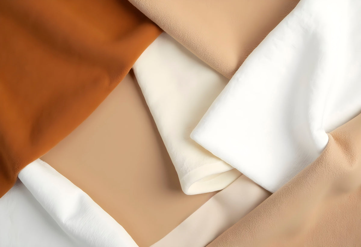 Soft folds of ivory, sand and warm caramel upholstery fabric