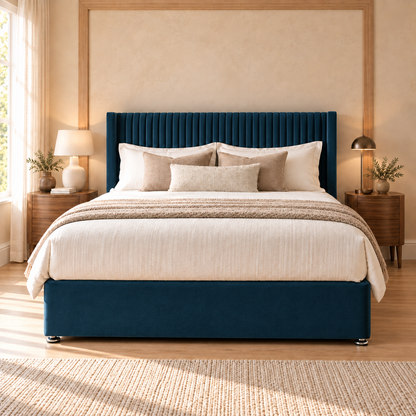 Ashbourne Divan Bed Frame, blue velvet and narrow pleated winged headboard, straight-on front view. AI-generated product illustration.