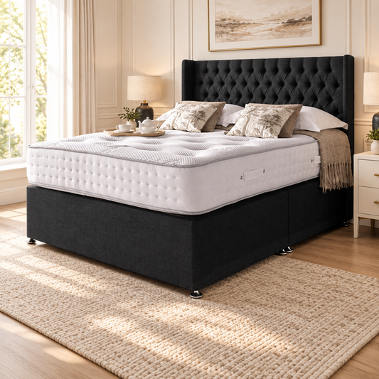 Chesterfield Wing Divan Bed Frame in a warm neutral bedroom, showing the upholstered headboard and base